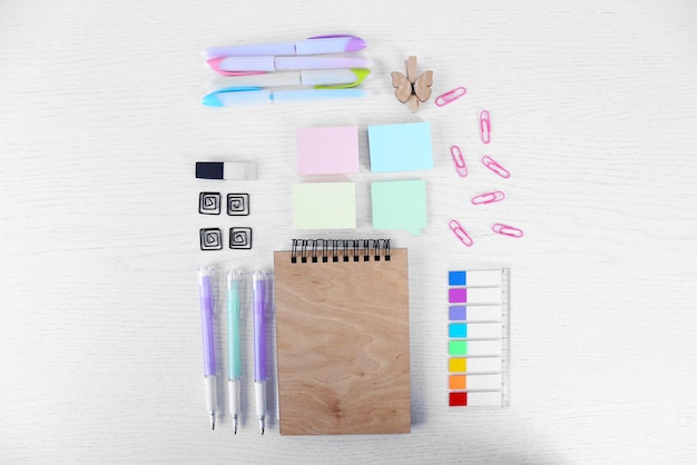 Notebook with stationery on a white table