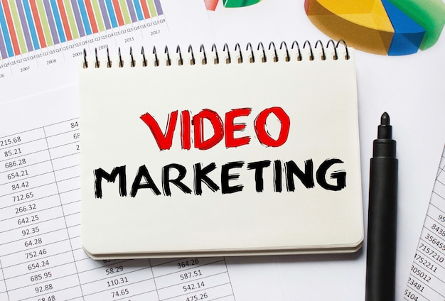 Notebook with Tools and Notes About Video Marketing