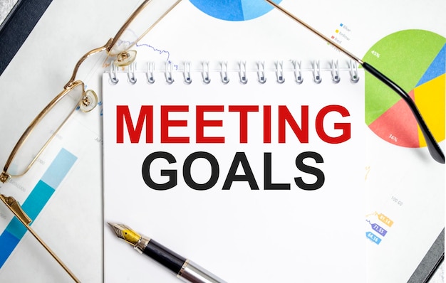 Photo notebook with tools and notes with text meeting goals