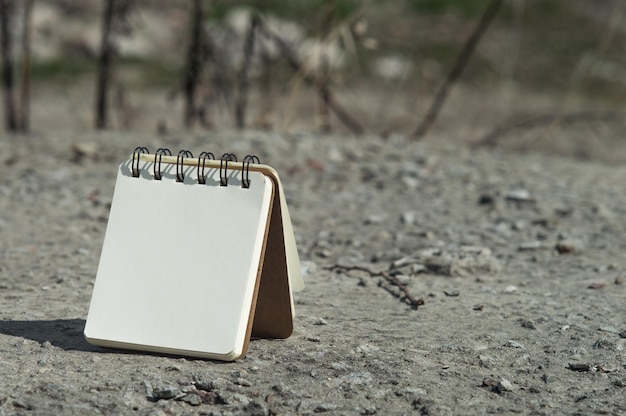 Notebook with white paper on the ground Closeup photo of notebook Mockup for records