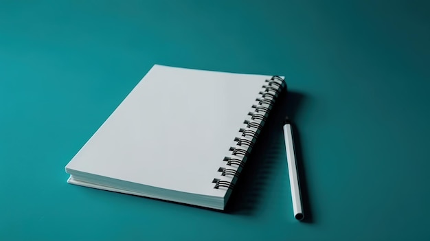 A notebook with a white pen sits on a teal background.