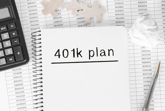 Photo notebook with word 401k plan on financial background