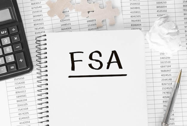 Notebook with word FSA on financial background