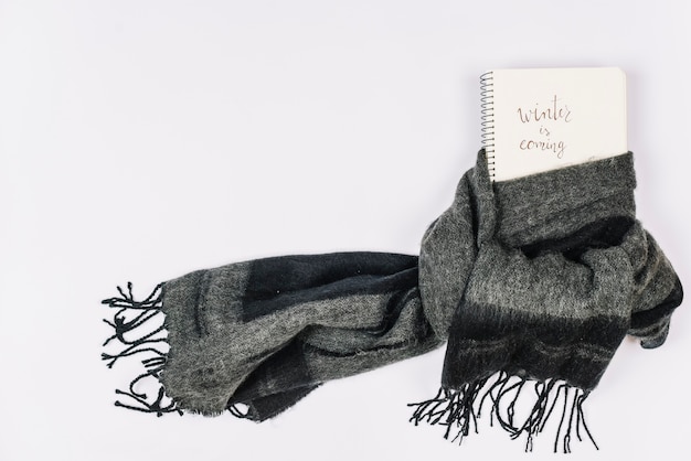 Notebook wrapped in warm gray scarf