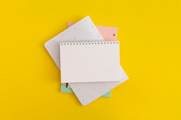 Notebook on yellow background. Top view. Flat lay. Back to school concept.