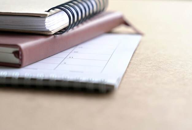 Notebooks and calendar on table Copy space