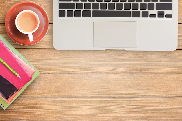 Notebooks and laptop on office desk or wood table