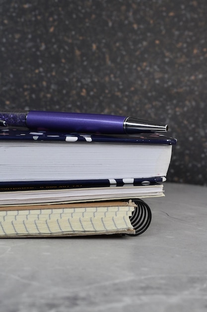 notebooks and a pen on the table