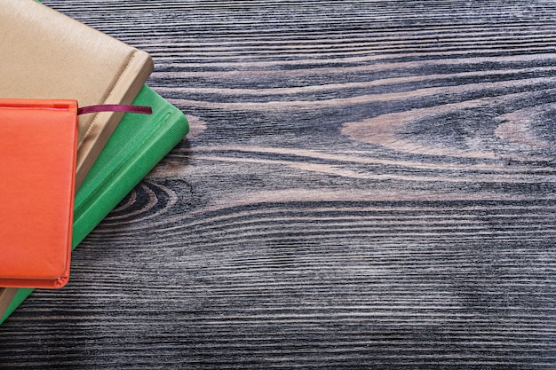 Notebooks on vintage wooden board office concept