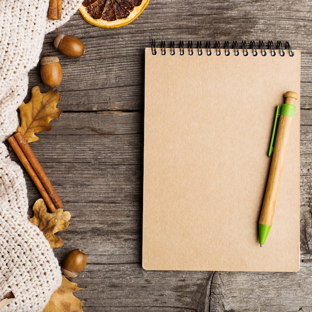 Notepad, cloth, leaves and dried orange