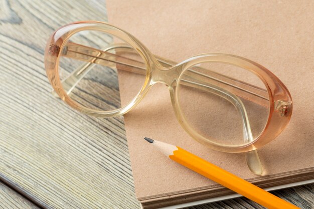 Notepad and eyeglasses on the table