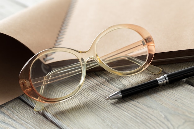 Photo notepad and eyeglasses on the table