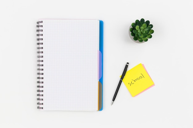 Notepad glasses and pen on a white background top view