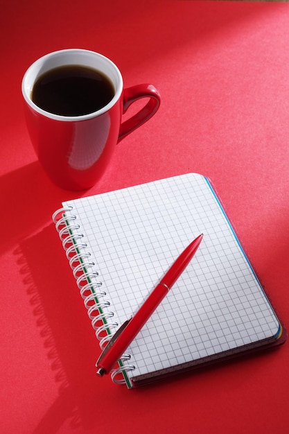 Notepad and pen with coffee