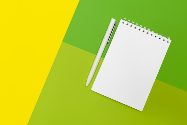 Notepad and pens on multicolor background