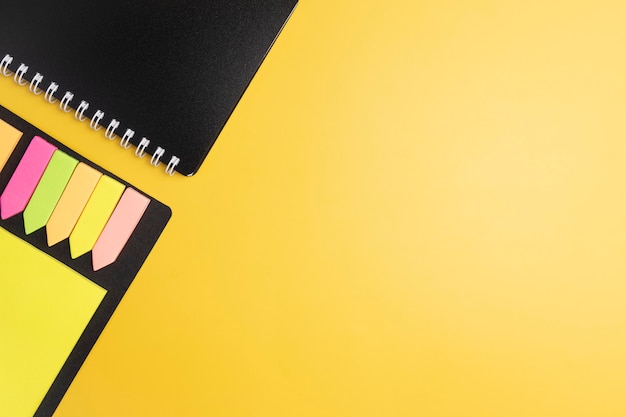 Notepad and sticker on a yellow background.