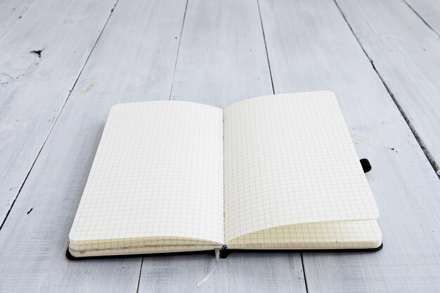 Notepad on white wooden background