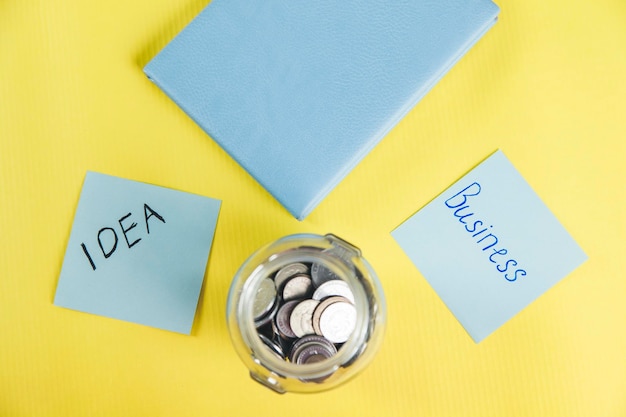 Notepad with coins on desk