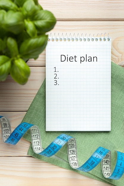 Photo notepad with diet plan, diet concept on wooden