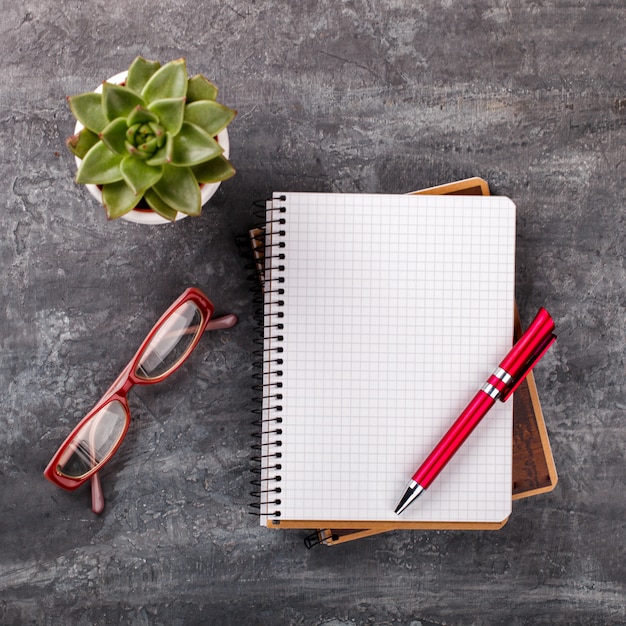 Notepad with pen, glasses , and flower . Business Concept 