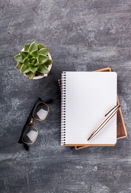 Notepad with pen, glasses  and flower 