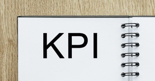 Блокнот с текстом KPI на деревянном столе. Концепция бизнеса и финансов