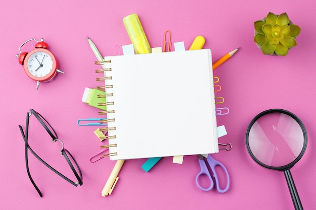 Notepad with wooden words on pink background