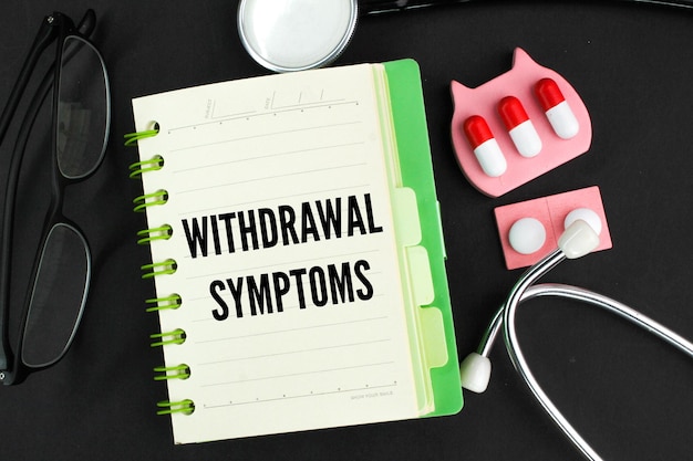 A notepad with the words withdrawal symptoms on it