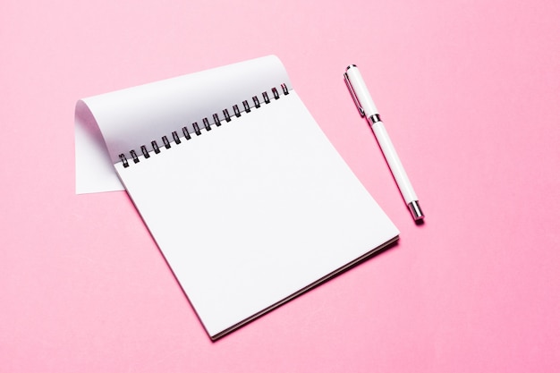 Notes pad on pink background