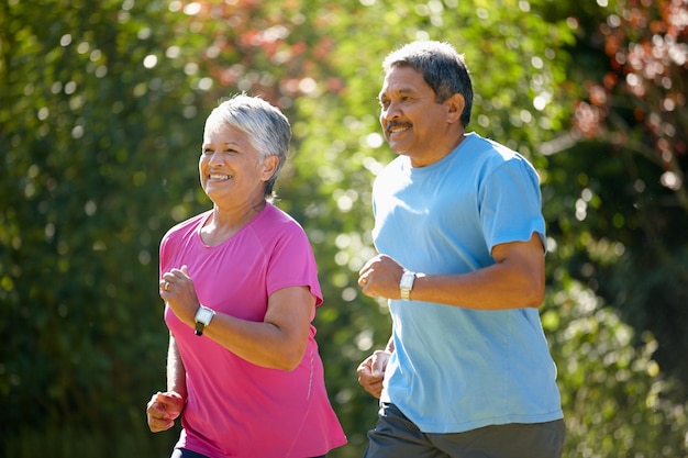 Nothing better than a sunny day run Shot of a mature couple jogging together on a sunny day