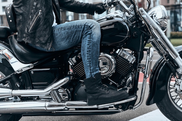 Nothing comes between him and his bike. Close up of man sitting on the motorbike 
