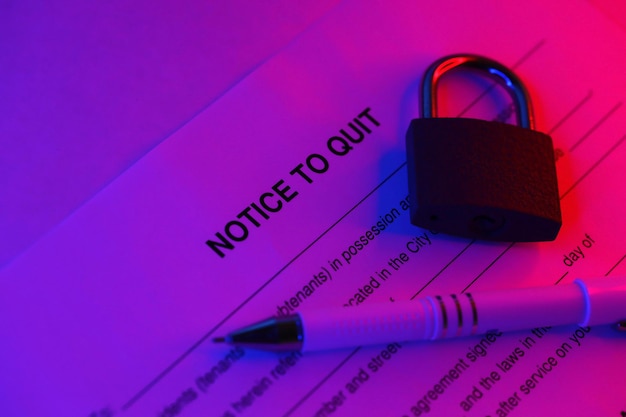 Notice to quit blank form with pen and small padlock on office table
