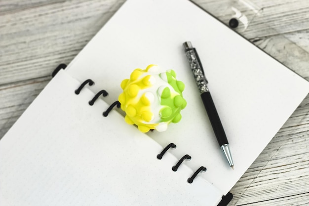 Notitieboek met pen en antistressbal op het bureaublad