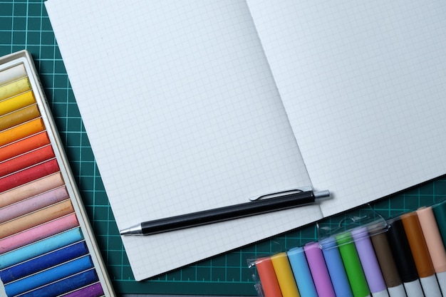 Notitieboekje en gekleurde pennen van begin tot het schooljaar.