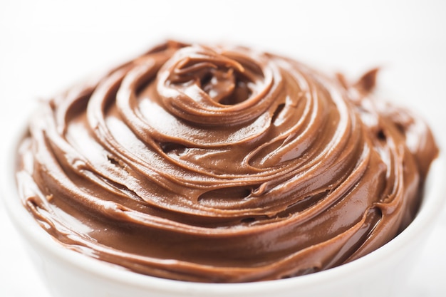 Nougat nut chocolate in a plate on a white background. Selective focus.