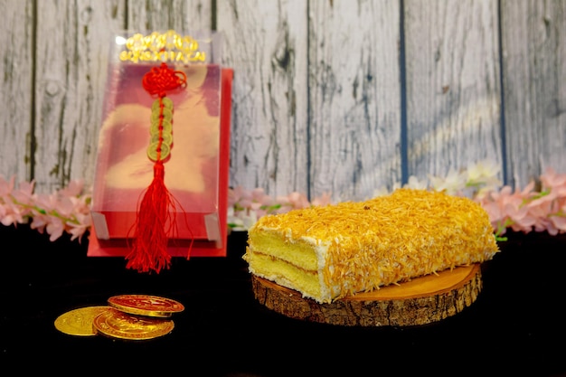 Noughat cake with box on the wooden plate