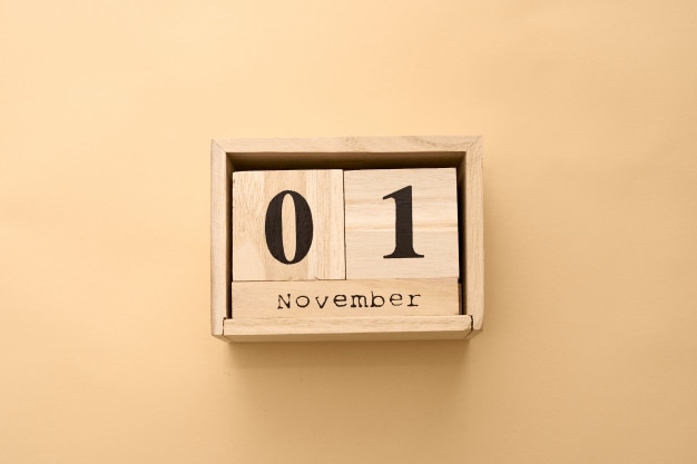 November 1st. Day 1 of November set on wooden calendar on on beige 