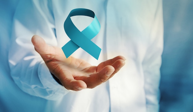 Photo november prostate cancer awareness month blue ribbon. men cancer prevention