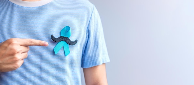 November prostate cancer awareness month blue ribbon with\
mustache for supporting people living and illness healthcare\
international men father and world cancer day concept