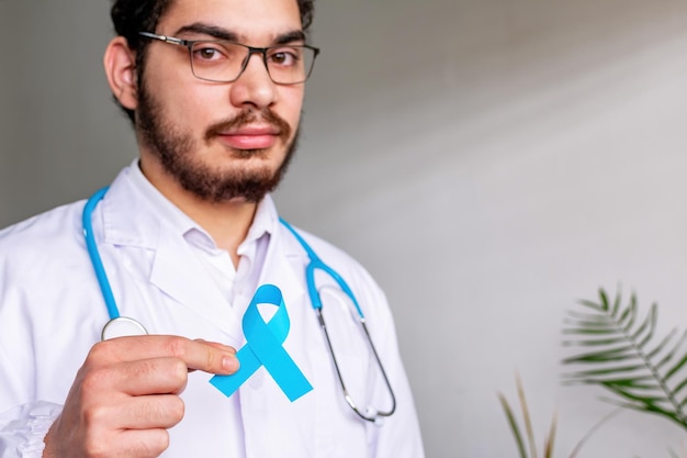 November prostate cancer awareness month doctor with blue ribbon for supporting people living