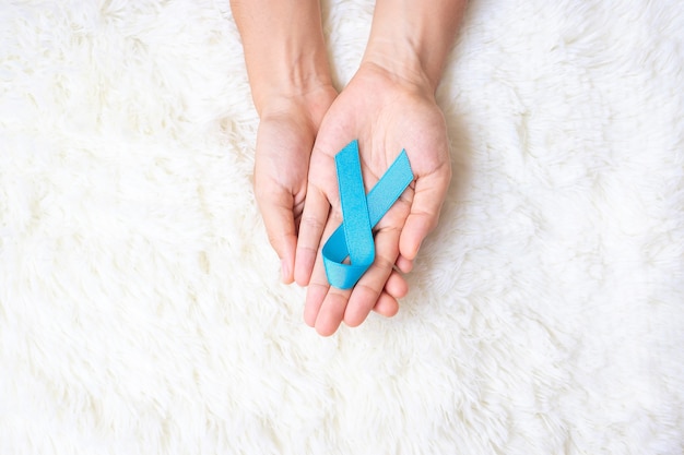 November Prostate Cancer Awareness month, Man holding light Blue Ribbon for supporting people living and illness. Healthcare, International men, Father, World cancer day and world diabetes day concept