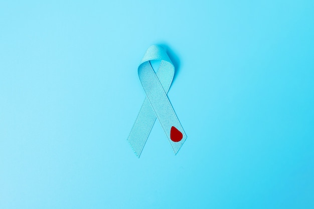 November World Diabetes day Awareness month, light Blue Ribbon with red blood drop for supporting people living, prevention and illness. Healthcare, prostate cancer day concept