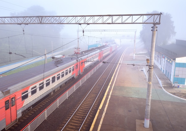 Novosibirsk, Siberia, Russia-08.15.2021: The cars of the suburban train of the Russian Railways on the rails of the platform of the railway station