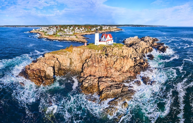 Nubble Lighthouse island off of Maine coast with ocean waves