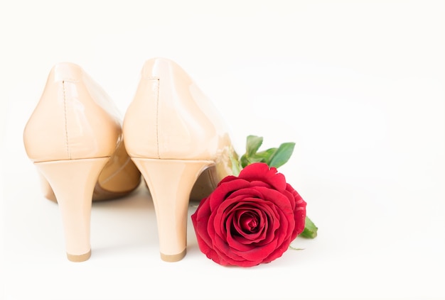 Nude colored high heels still life with red rose