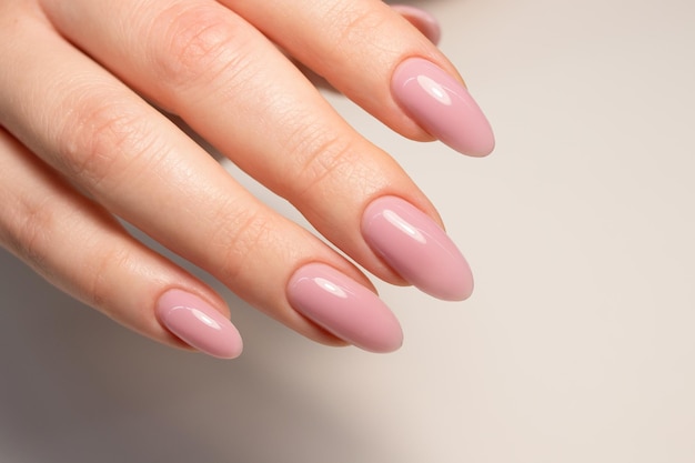 Nude manicure Pink gel nail polish Almond shaped nails