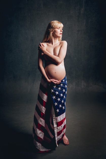 Nude pregnant woman with american flag.