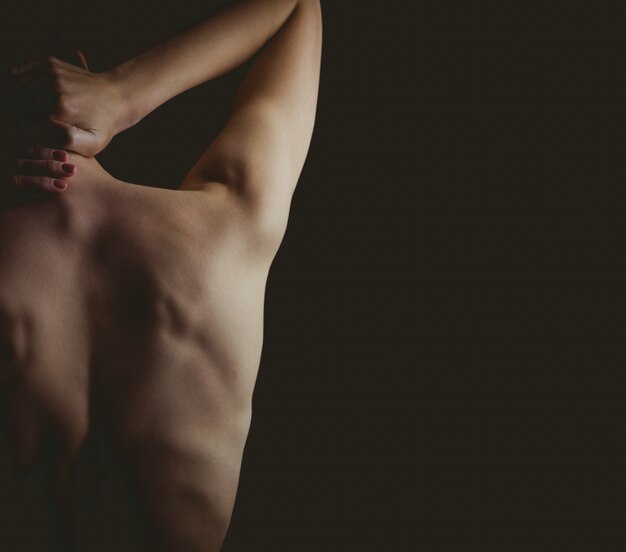 Nude woman with a neck injury