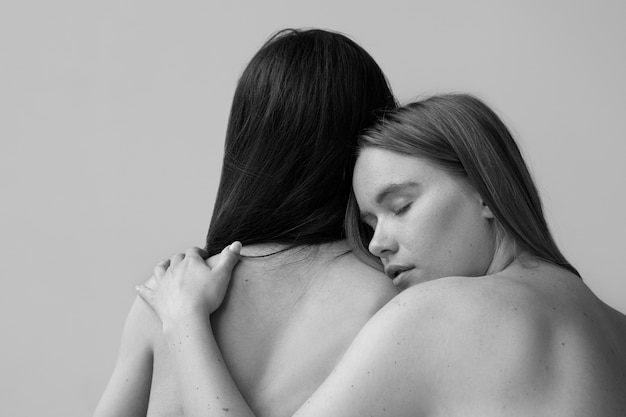 Nude women hugging