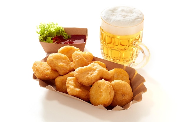 Nuggets and beer on white table